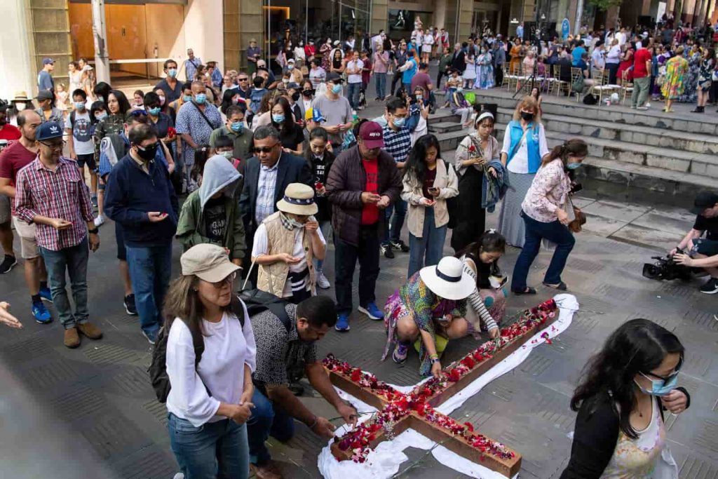 Wierni składają kwiaty na krucyfiksie podczas Wielkopiątkowego Marszu Ukrzyżowania w Sydney, Australia